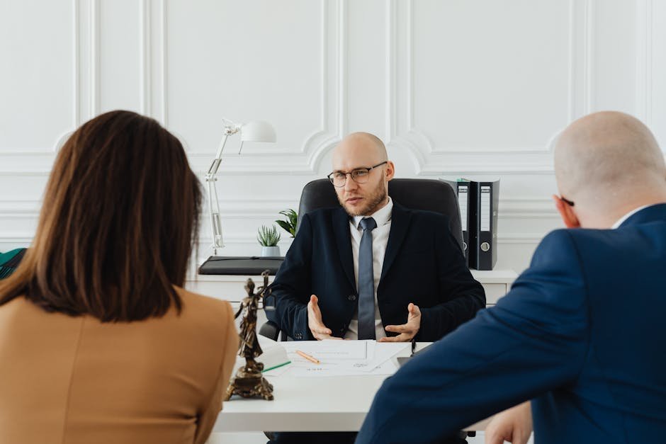 Bankruptcy attorney explaining exemption schedule to client with documents on desk