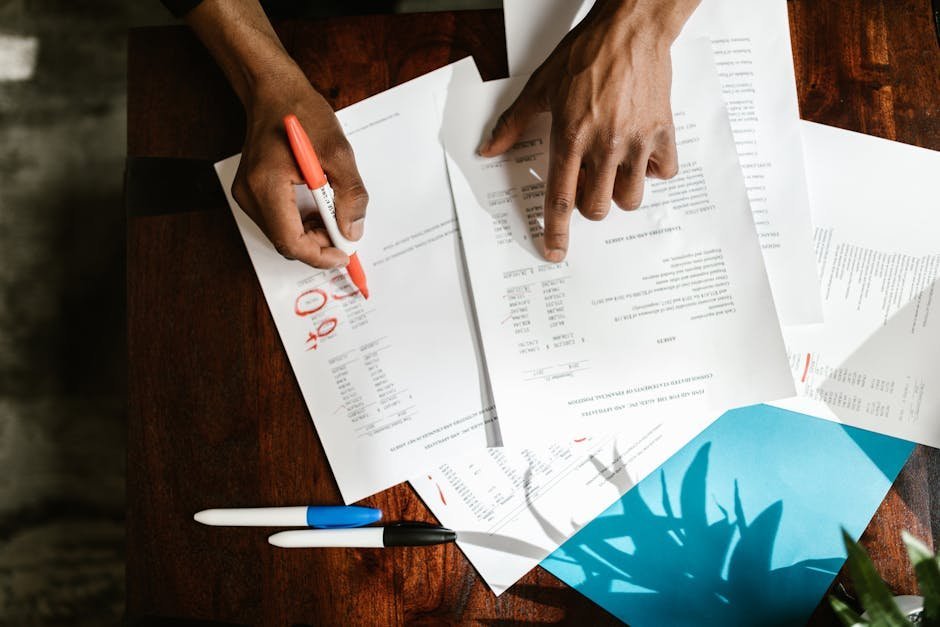 Person reviewing critical illness insurance brochure at a kitchen table