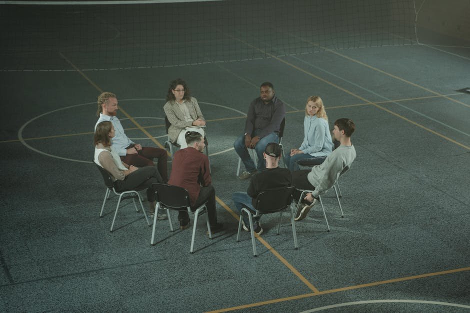 Group therapy room with chairs arranged in a circle and DBT skills posters