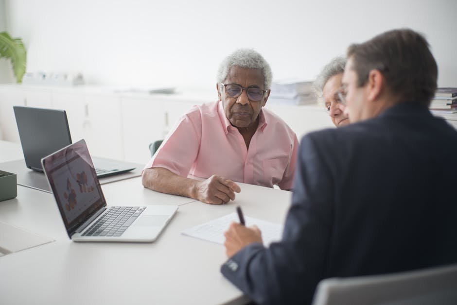 Senior couple meeting with insurance broker reviewing Medigap and indemnity options