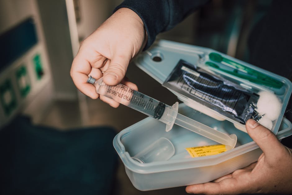 Nurse preparing home medication kit with pill organizer and CIWA assessment sheet