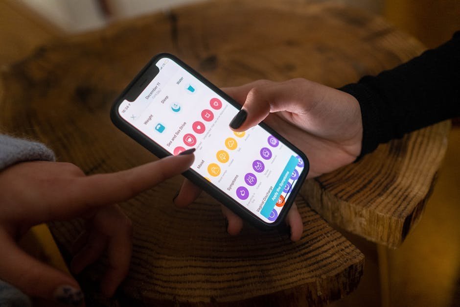 Person checking sleep tracker app on smartphone in dim bedroom showing disrupted sleep stages