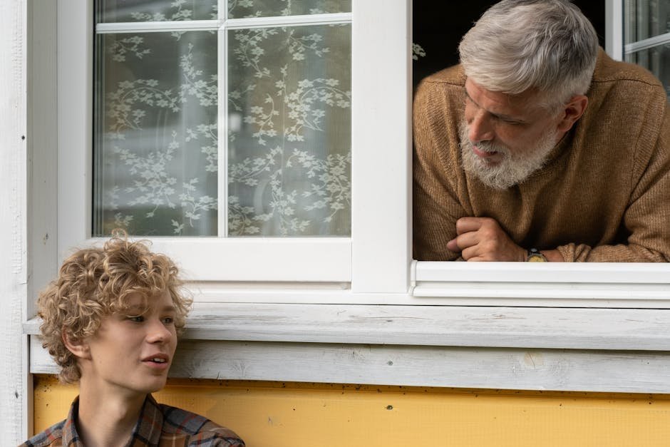 Older man and teenage mentee talking over coffee at a community centre