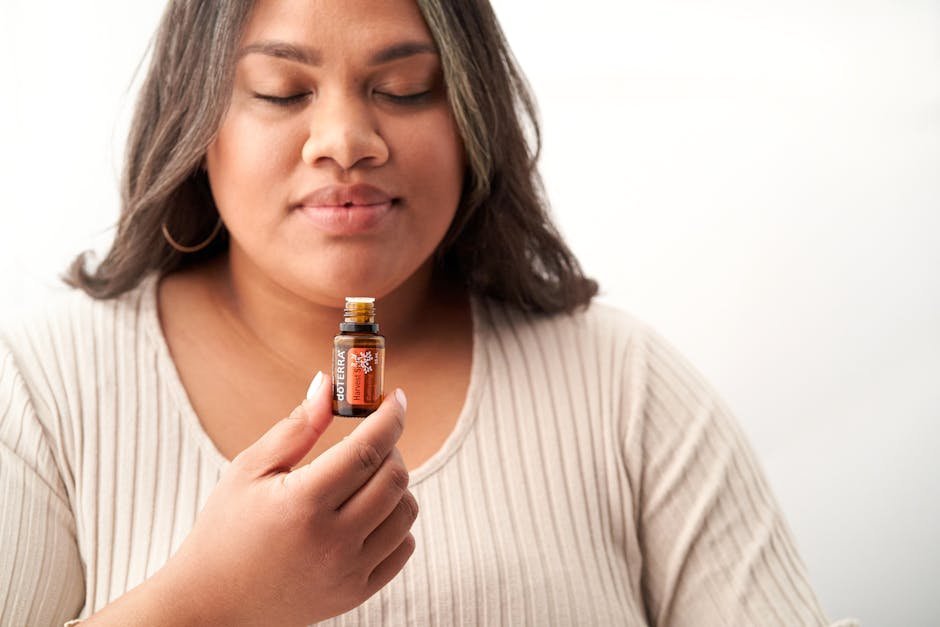 Personal aromatherapy inhaler stick next to a small bottle of carrier oil