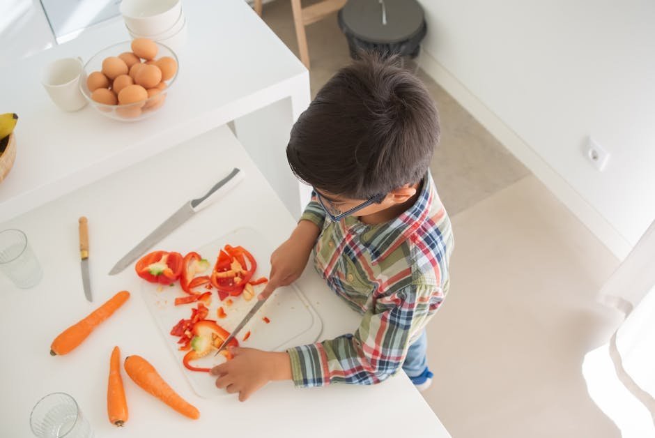 A teaching kitchen with several people learning to chop vegetables together