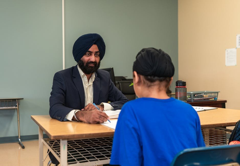 School counselor meeting one-on-one with student in recovery high school office