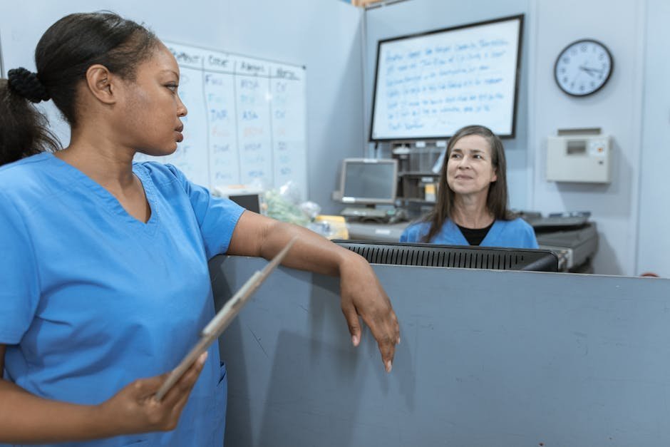 Nurse in scrubs receiving counseling at healthcare professional recovery program