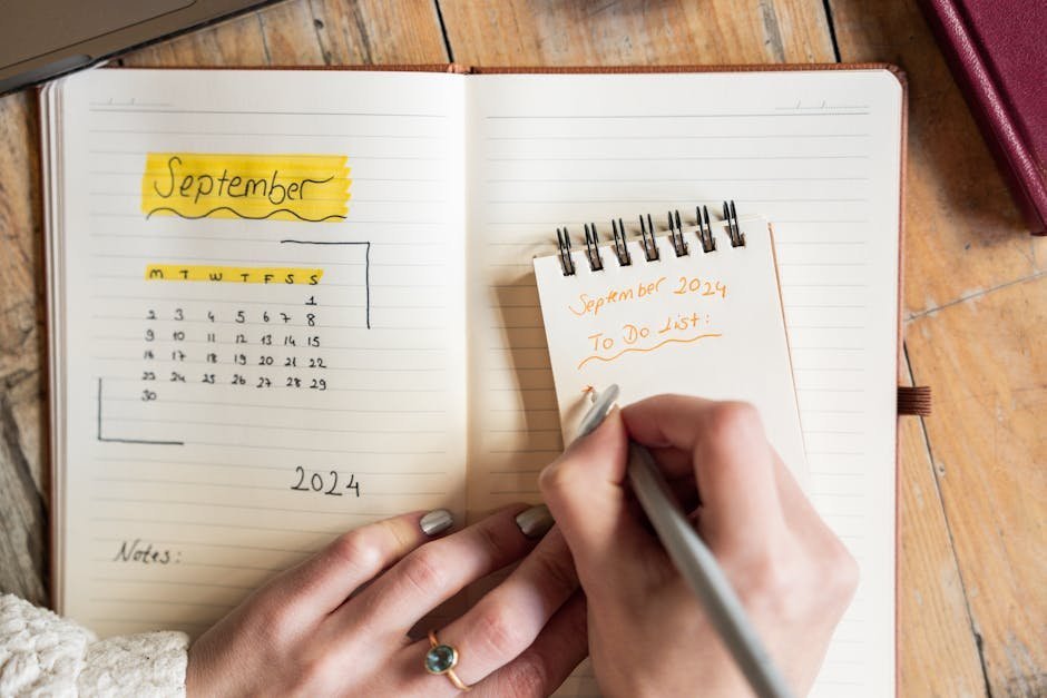 Person sitting calmly with a simple bullet journal and pen, focused on three daily priorities