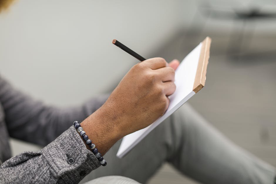 Person writing thoughtfully in a journal about personal values and what matters most to them