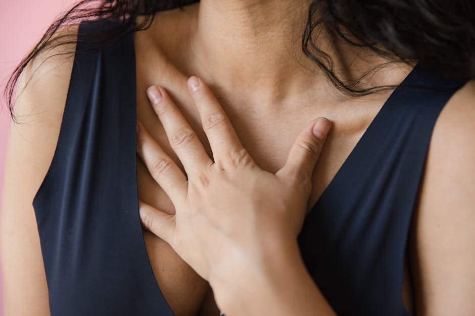 Hand resting gently on chest in a self-compassion practice during quiet moment of reflection