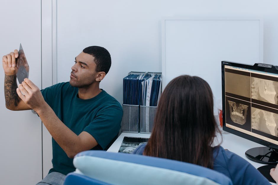Patient and sleep specialist reviewing CPAP adherence data and apnea-hypopnea index trend on tablet during follow-up visit