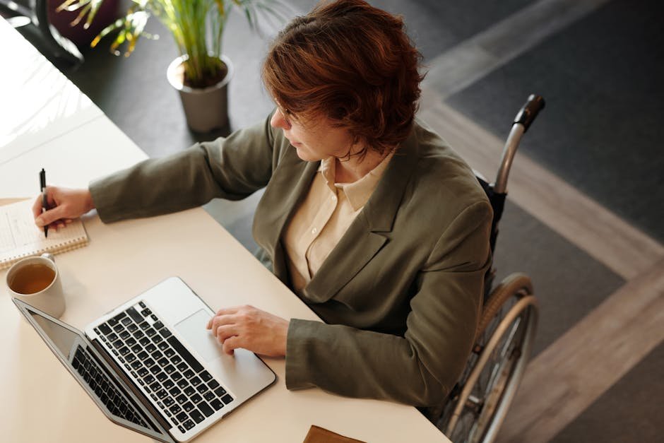 Disability claim paperwork beside a laptop