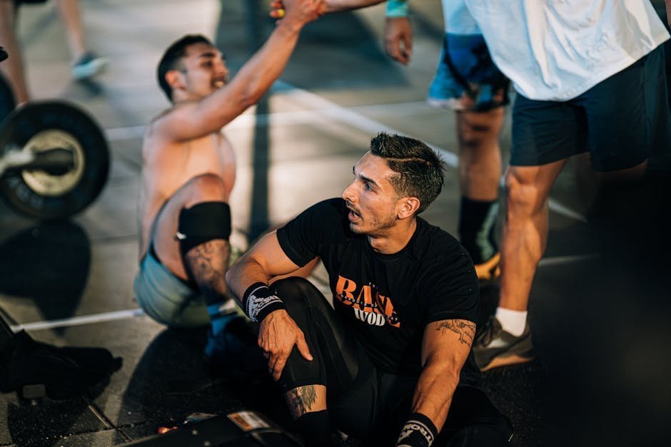 CrossFit class members cheering on a participant during a group workout