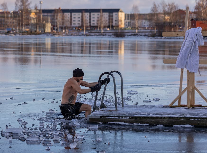 A person stepping into an outdoor cold plunge tub after a sauna session