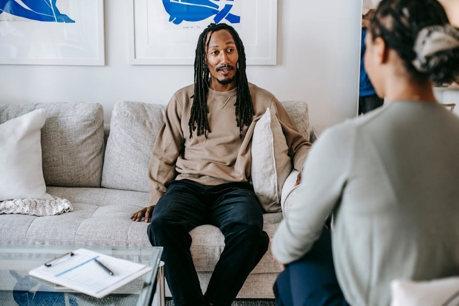 Peer support specialist in conversation with a guest at a respite house kitchen table