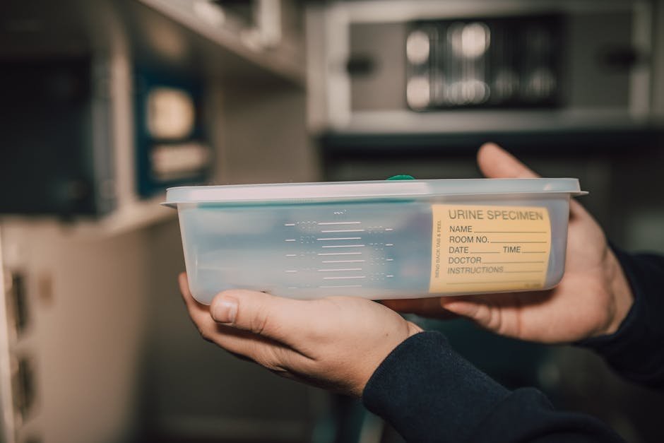ER physician reviewing urine drug screen and ECG results during acute mania workup