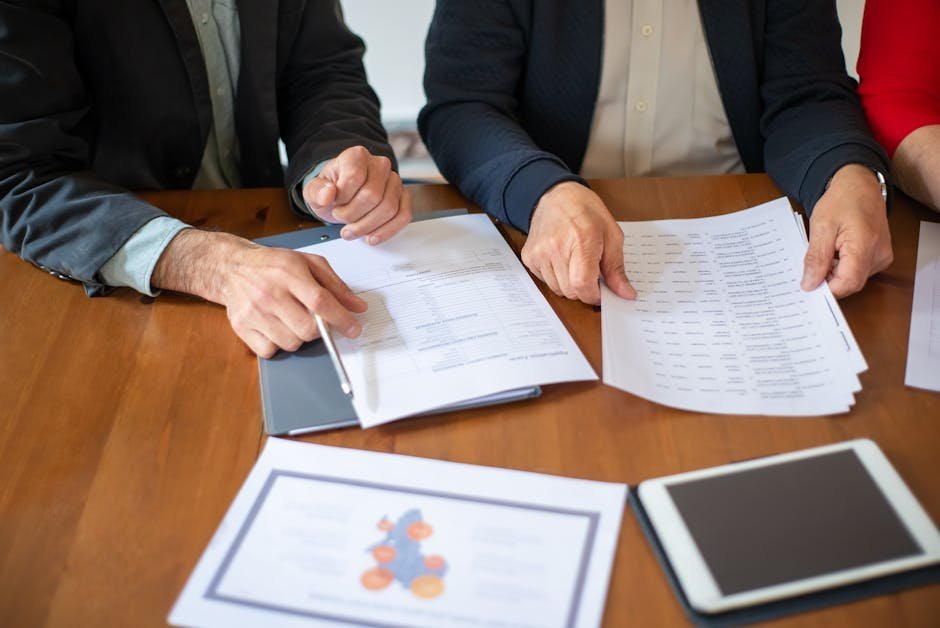 Veteran reviewing paperwork with a social worker at a desk in a quiet office