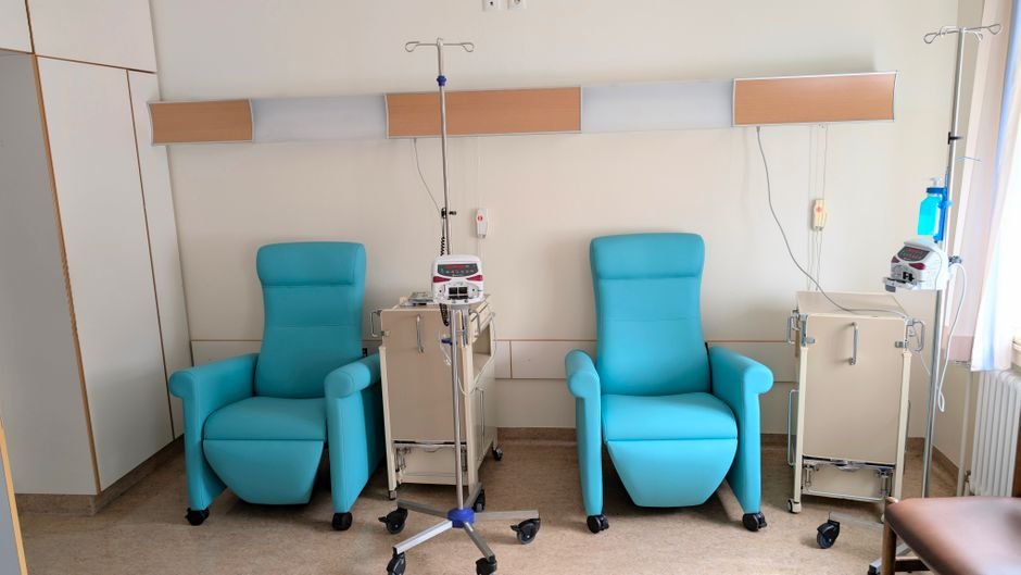 A calm, dimly lit clinic room with a reclining chair where someone might receive ketamine therapy for depression